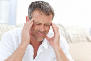 Man having a headache at home | Healthier Me Today