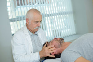 Doctor massaging patient's head | Healthier Me Today