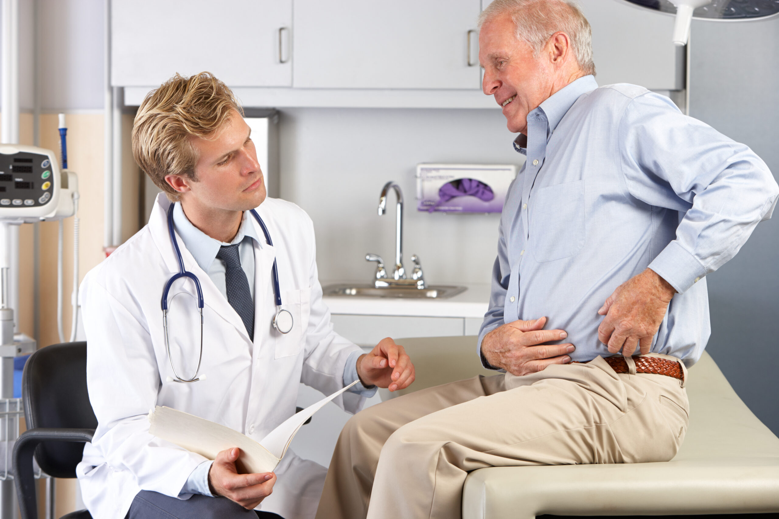 Doctor Examining Male Patient With Hip Pain | Healthier