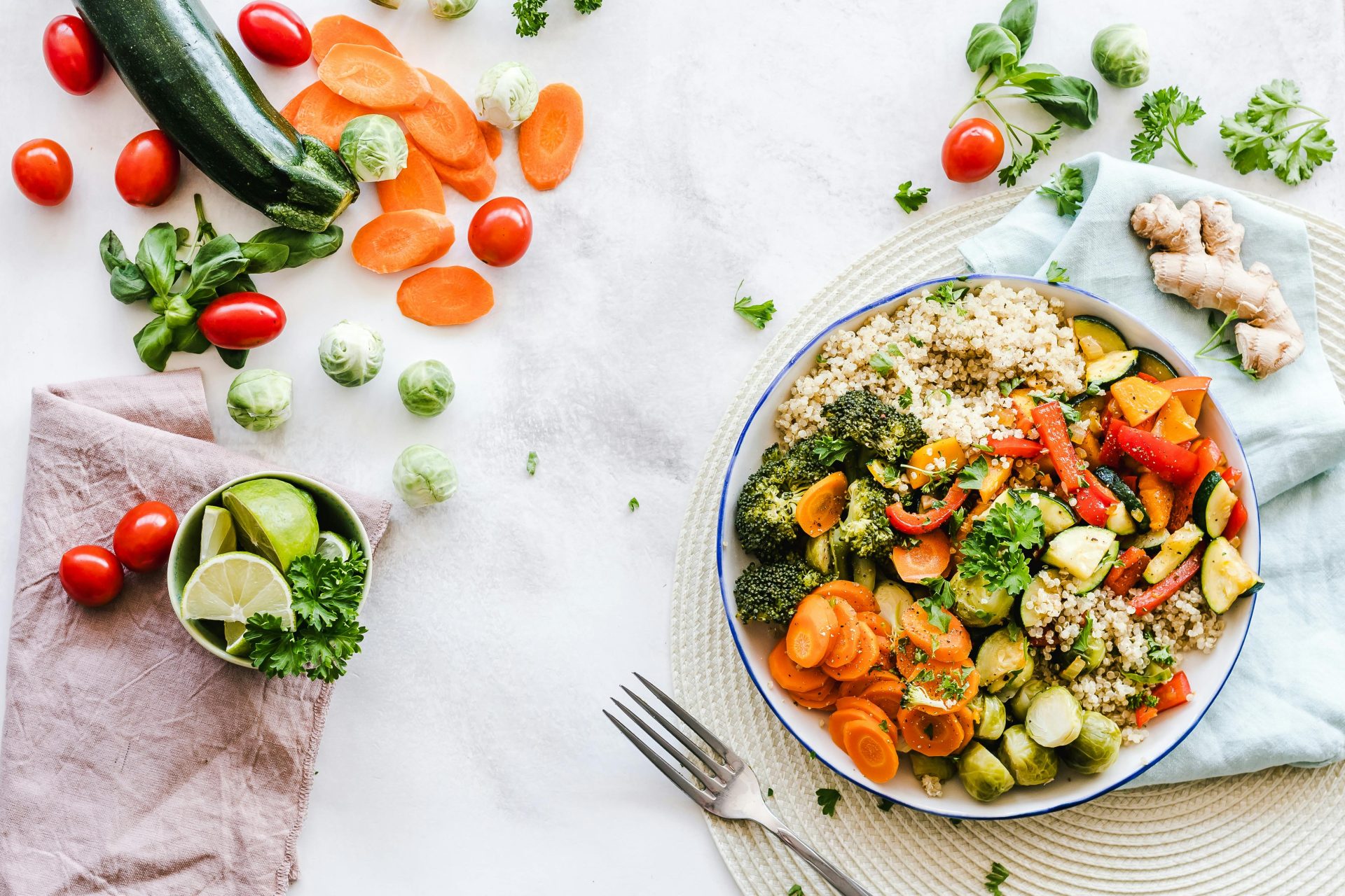 balanced nutrition secrets, color healthy food in bowl, food al other counter, white counter, fork // Healthier Me Today