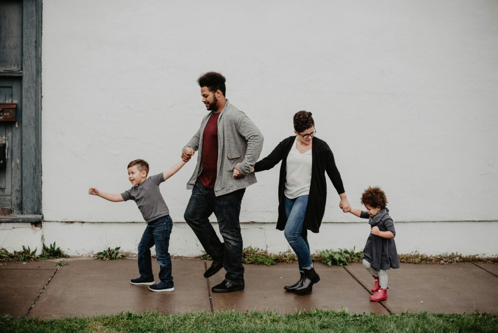 family of 4, holding hands, wet pavement, white wall, old door // Healthier Me Today