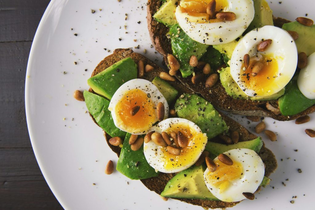 avocado, boiled egg and bean on bread, white round plate // Healthier Me Today