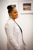 woman doctor, dark hair, tied up, big earrings, white coat, smiling, white wall, blurred background // Healthier Me Today