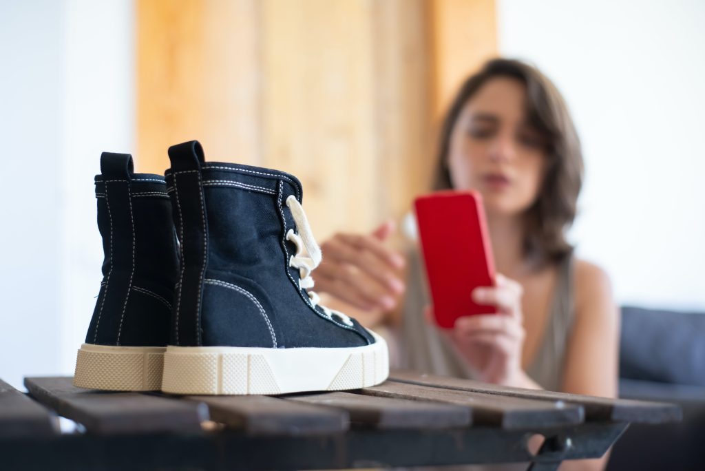 woman taking photo of shoes, small business, blurred background // Healthier Me Today