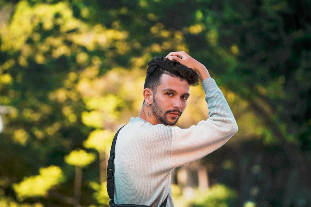 male anorexia, park setting, man looking back, touching his hair, wearing white // Healthier Me Today