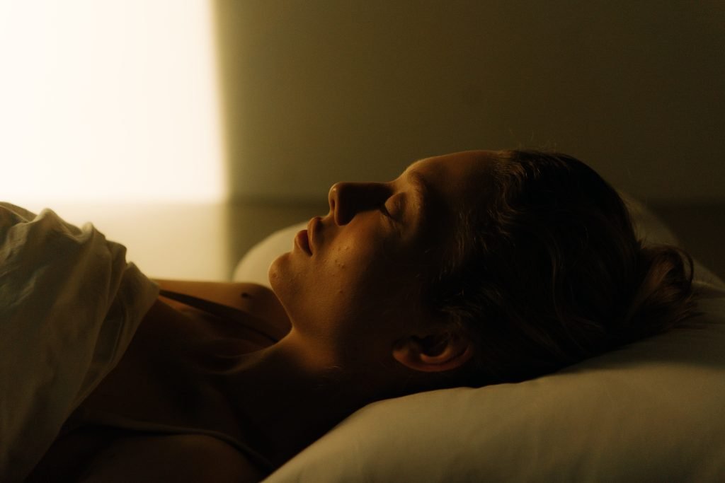 woman sleeping, side profile dimmed light, beige colors, light shinning from window // Healthier Me Today