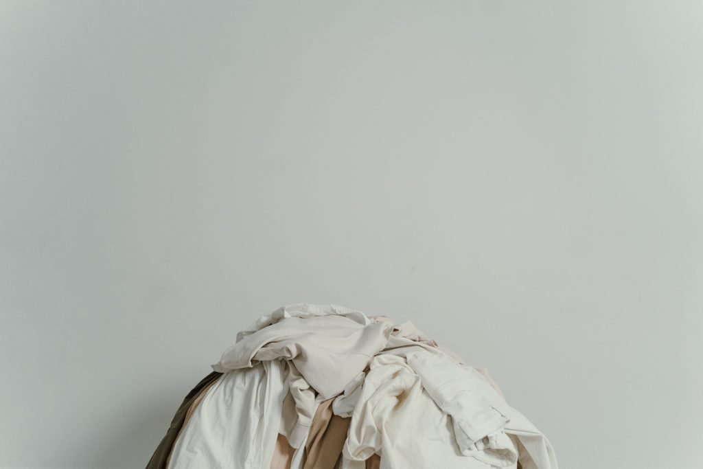 white wall, pile of clothes on the floor // Healthier Me Today
