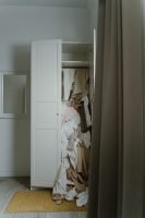 bedroom, white walls, grey curtains, white small closet, clothes falling out of closet // Healthier Me Today