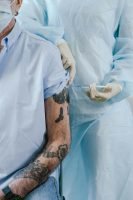 tattood arm getting an injection, treatment, blue scrubs, masks // Healthier Me Today // Male Breast Cancer
