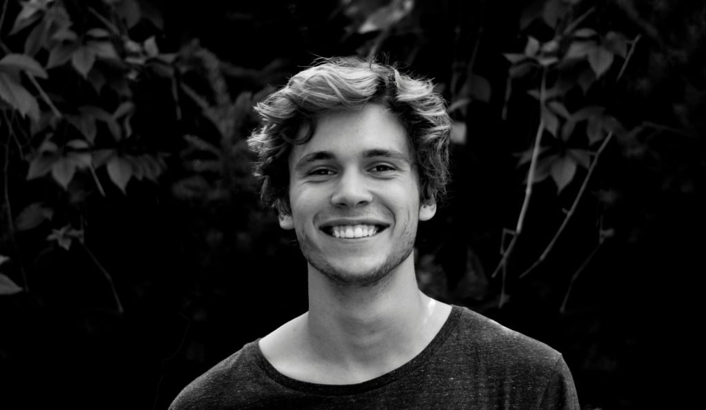 man smiling, long dark hair, trees, black and white photo // Healthier Me Today
