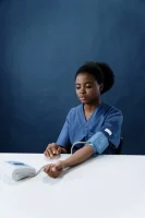 A Healthcare Worker Measuring Her Own Blood Pressure Using a Sphygmomanomet // Healthier Me Today