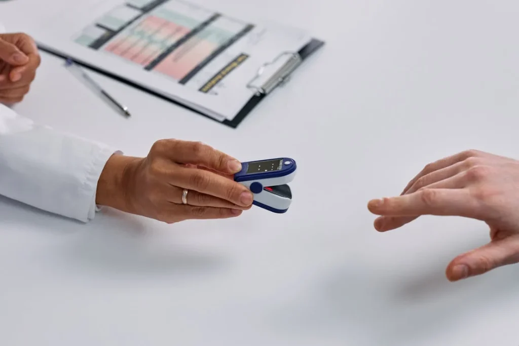 Close-up of Doctor Putting a Fingertip Pulse Oximeter on a Patients Finger // Healthier Me Today