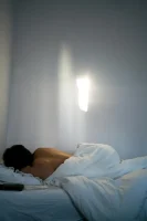 Unrecognizable person with bare back sleeping in bed // Healthier Me Today