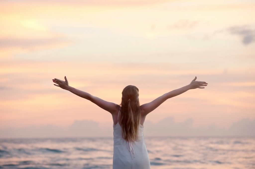 Rear View of Woman With Arms Raised at Beach during Sunset // Healthier Me Today