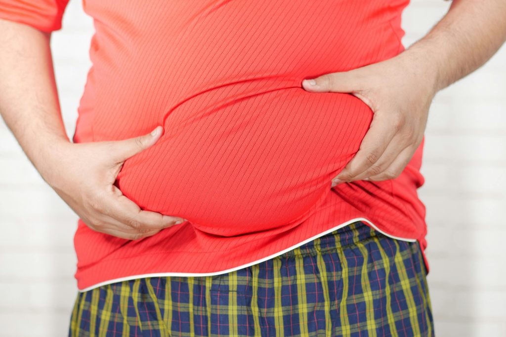 signs of liver detox working or not, Close-up Photo of Person holding his Belly // Healthier Me Today